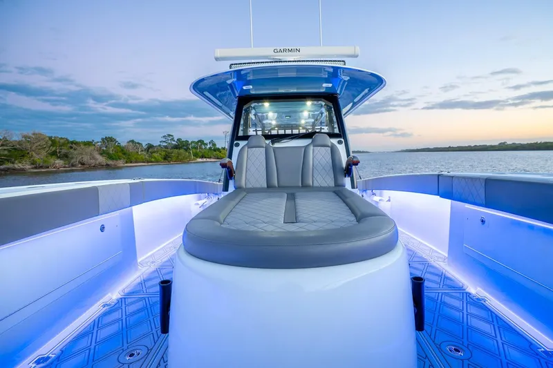 Slide: The Image of 2025 Freeman 43 boat interior with modern seating and ambient lighting at sunset. - 15