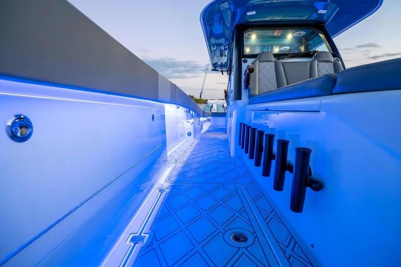 Slide: The Image of 2025 Freeman 43 boat interior with blue LED lighting and modern seating. - 17
