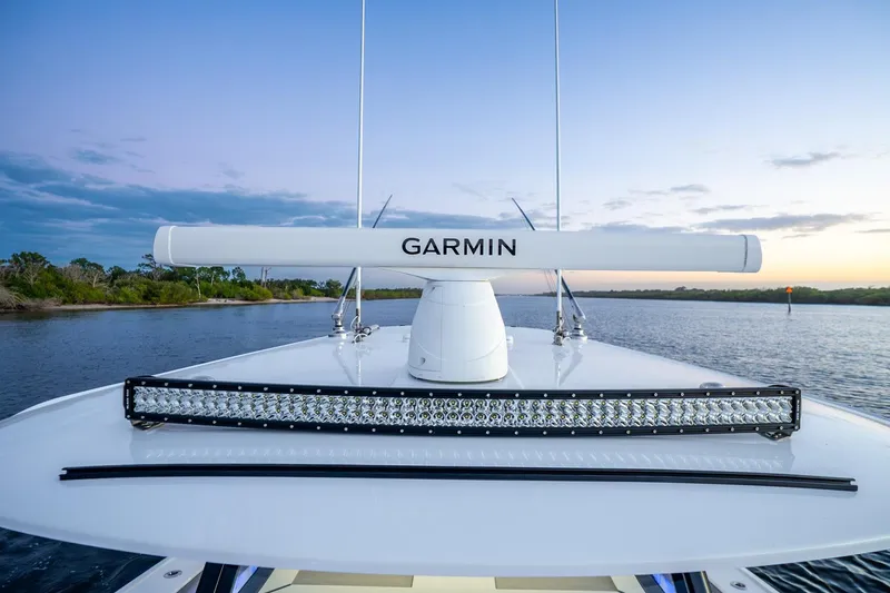 Slide: The Image of 2025 Freeman 43 boat with Garmin radar and LED light bar on calm water at sunset. - 18