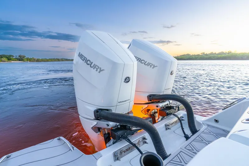 Slide: The Image of Freeman 43 boat with dual Mercury outboard engines at sunset, 2025 model. - 25