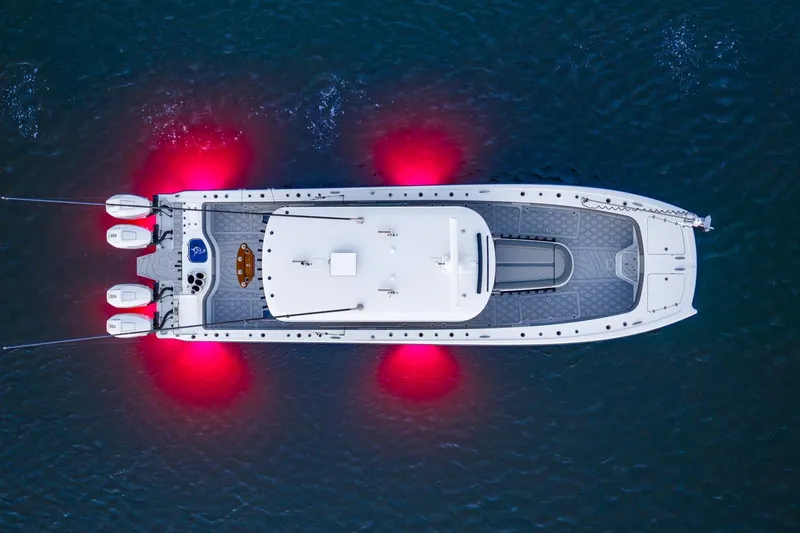 Slide: The Image of 2025 Freeman 43 boat on water at sunset with fishing rods and engines. - 3