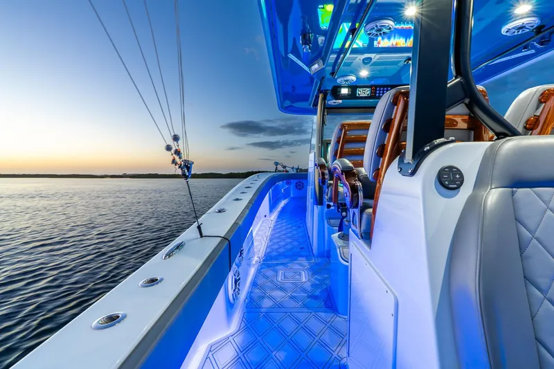 Slide: The Image of Luxurious 2025 Freeman 43 boat interior with blue LED lighting at sunset on the water. - 30