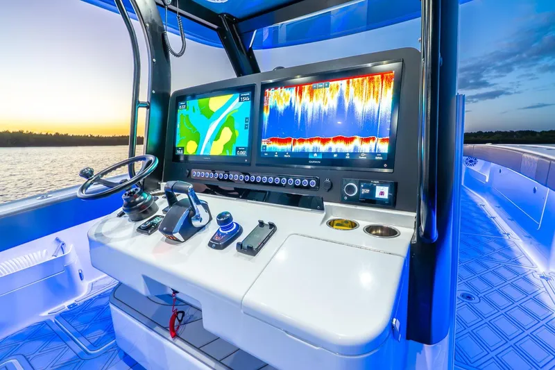 Slide: The Image of Control panel of 2025 Freeman 43 boat with navigation screens at sunset. - 32