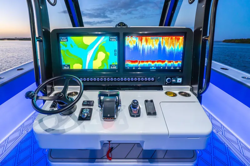 Slide: The Image of Modern helm of 2025 Freeman 43 boat with advanced navigation displays at sunset. - 33