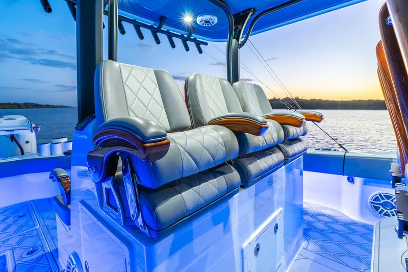 Slide: The Image of Luxurious seating on a 2025 Freeman 43 boat, illuminated by blue LED lights at sunset. - 40