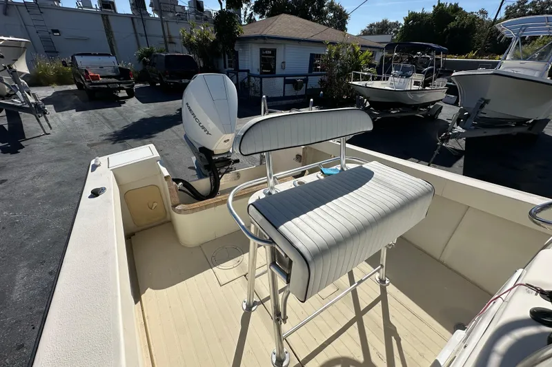 Slide: The Image of 1977 SeaCraft 23 CC boat interior with Mercury outboard motor, parked outdoors. - 10