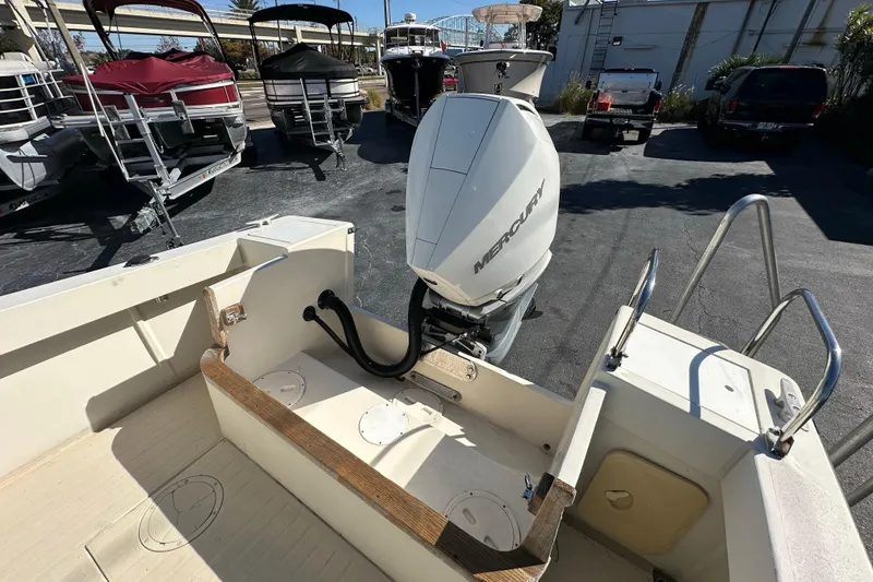Slide: The Image of 1977 SeaCraft 23 CC boat with Mercury outboard motor, docked among other boats. - 14