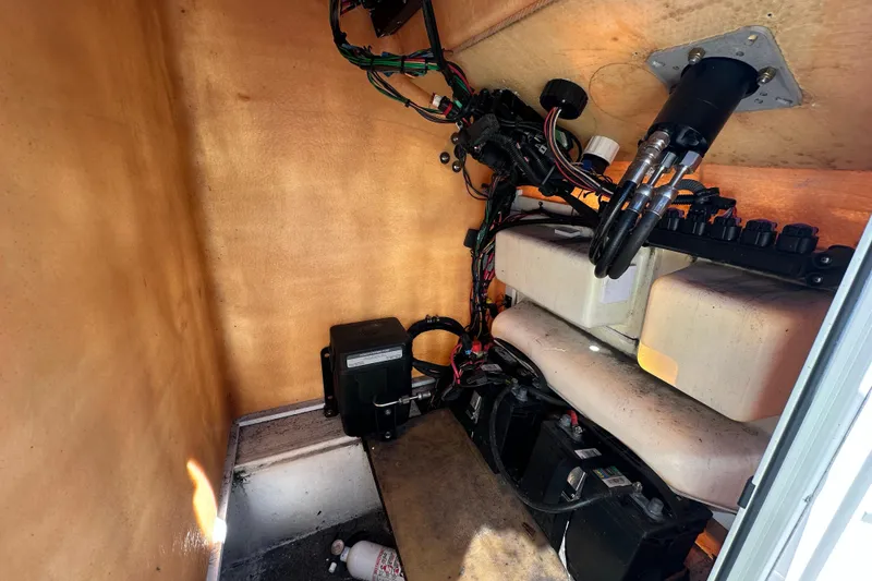 Slide: The Image of Interior view of a 1977 SeaCraft 23 CC boat showing wiring and equipment. - 16