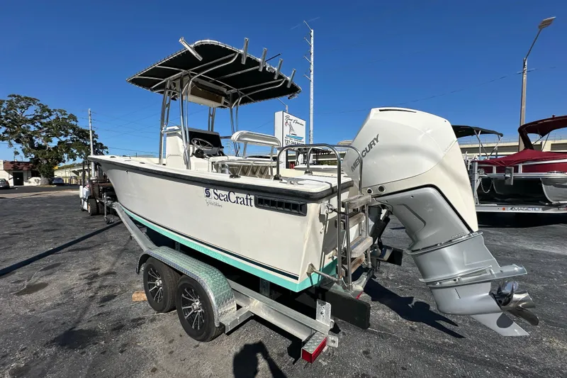Slide: The Image of 1977 SeaCraft 23 CC boat on trailer with Mercury outboard motor. - 2