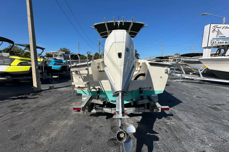 Slide: The Image of 1977 SeaCraft 23 CC boat on trailer, displayed in a boat dealership lot. - 3