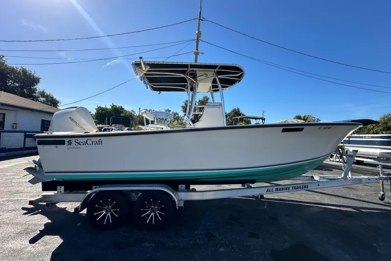 Slide: The Image of 1977 SeaCraft 23 CC boat on trailer, side view, clear sky background. - 5