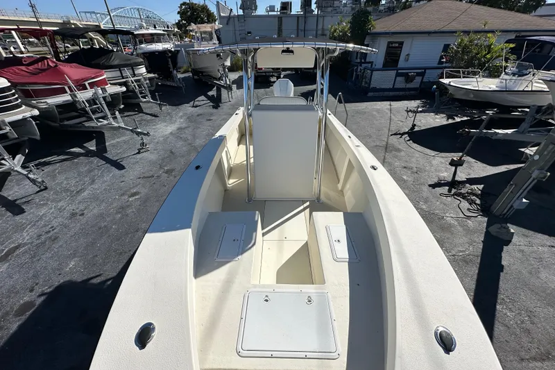Slide: The Image of 1977 SeaCraft 23 CC boat, center console, docked among other boats. - 6