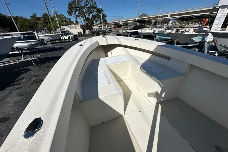 Slide: The Image of 1977 SeaCraft 23 CC boat interior with seating, parked in a marina. - 7
