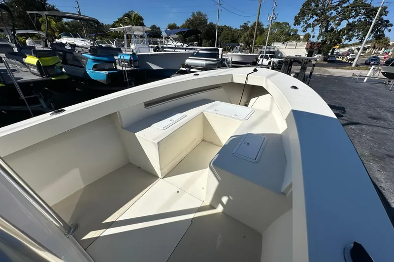 Slide: The Image of 1977 SeaCraft 23 CC boat interior with seating, docked among other boats. - 8