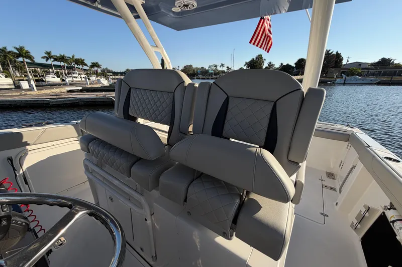 Slide: The Image of 2023 Pursuit S 328 Sport boat interior with luxurious seating and waterfront view. - 12