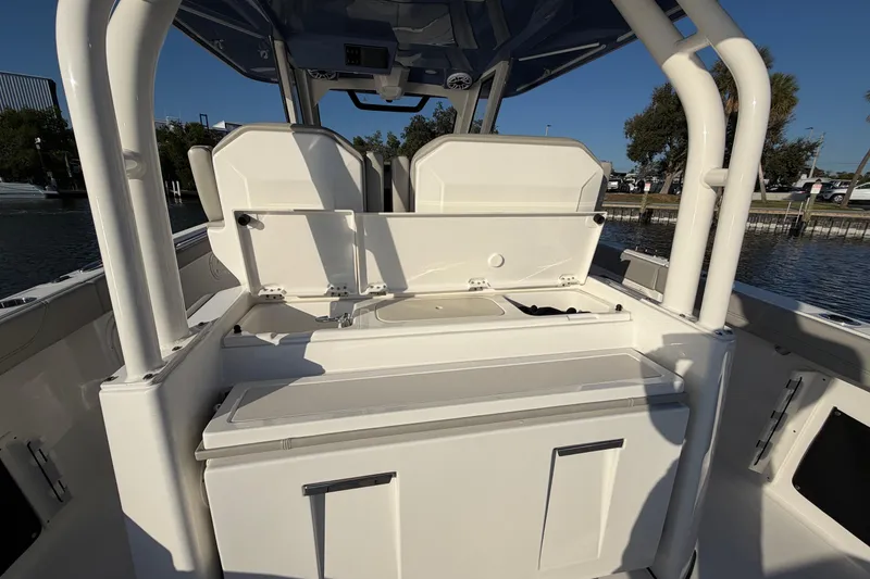 Slide: The Image of 2023 Pursuit S 328 Sport boat interior with open storage compartments. - 18