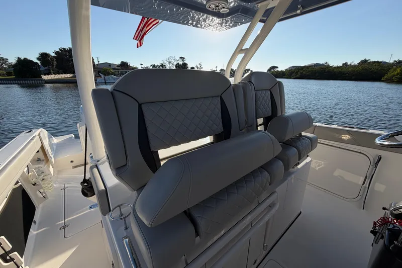Slide: The Image of 2023 Pursuit S 328 Sport boat interior with luxurious seating and scenic water view. - 22