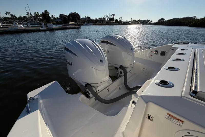 Slide: The Image of 2023 Pursuit S 328 Sport boat with dual Yamaha outboard engines on a sunny day. - 24