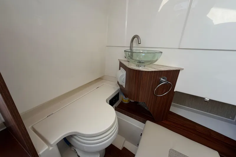 Slide: The Image of 2023 Pursuit S 328 Sport boat bathroom with modern sink and compact toilet. - 25