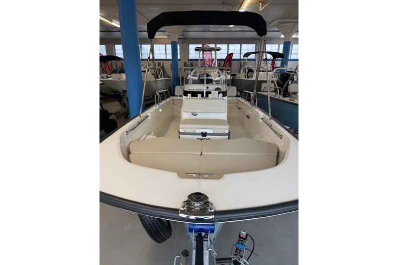 Slide: The Image of 2026 Boston Whaler 170 Montauk boat in showroom, featuring spacious interior and modern design. - 11