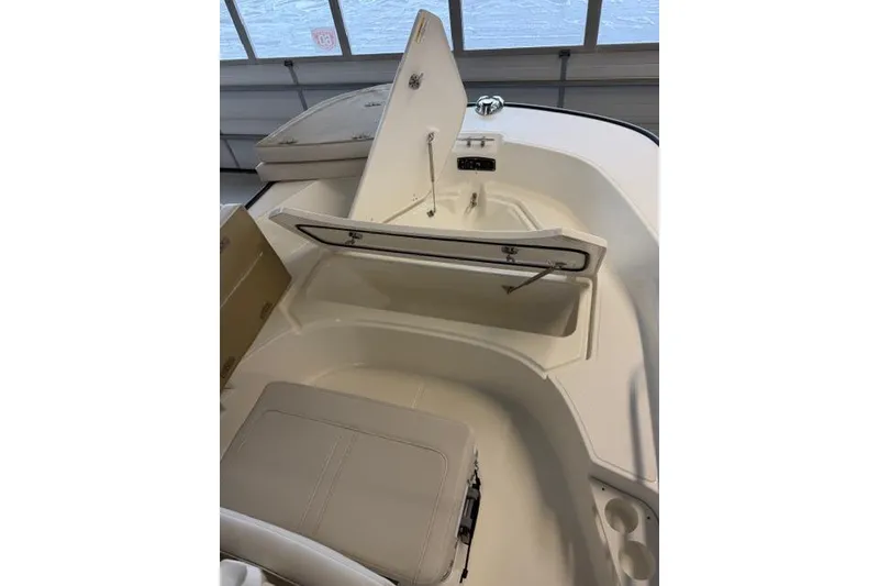 Slide: The Image of 2026 Boston Whaler 170 Montauk boat interior with open storage compartment. - 12