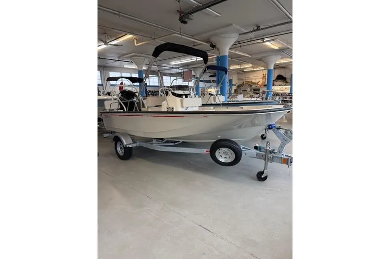 Slide: The Image of 2026 Boston Whaler 170 Montauk boat on trailer in indoor showroom. - 2