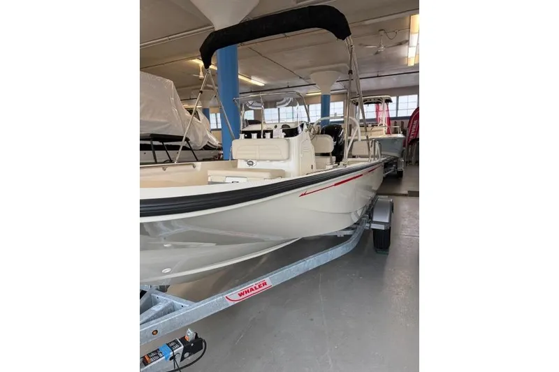 Slide: The Image of 2026 Boston Whaler 170 Montauk boat on trailer in indoor showroom. - 3
