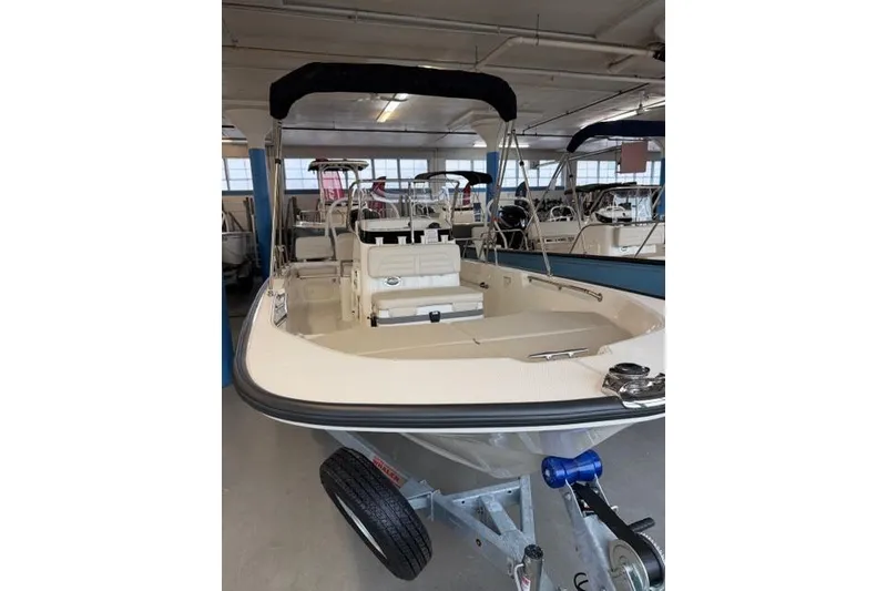 Slide: The Image of 2026 Boston Whaler 170 Montauk boat in showroom, front view on trailer. - 5