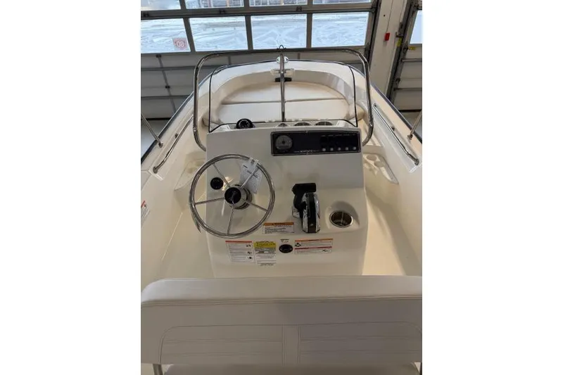 Slide: The Image of 2026 Boston Whaler 170 Montauk boat console with steering wheel and controls. - 7