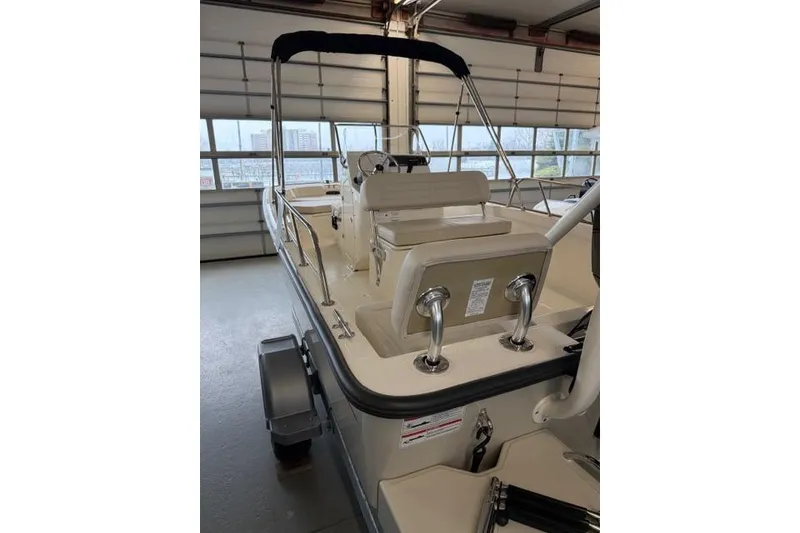 Slide: The Image of 2026 Boston Whaler 170 Montauk boat interior in a garage setting. - 8