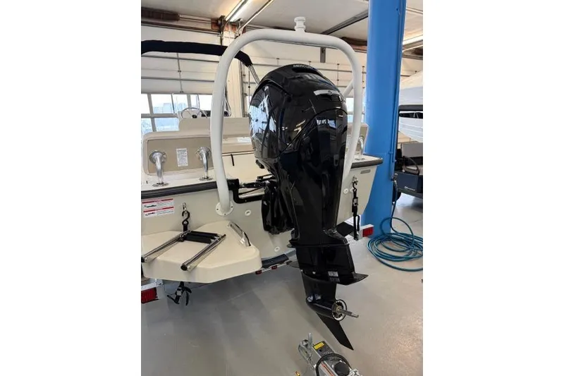 Slide: The Image of 2026 Boston Whaler 170 Montauk boat with powerful outboard motor in showroom. - 9