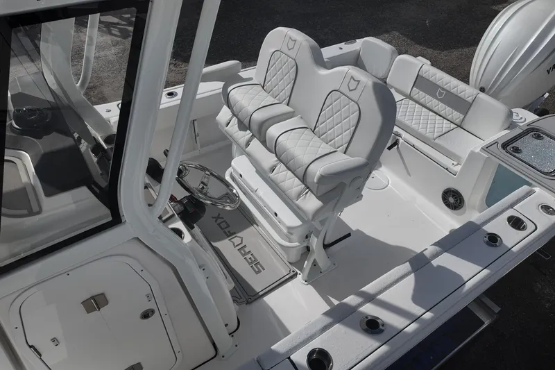 Slide: The Image of 2026 Sea Fox 248 Commander boat interior with cushioned seating and steering console. - 12