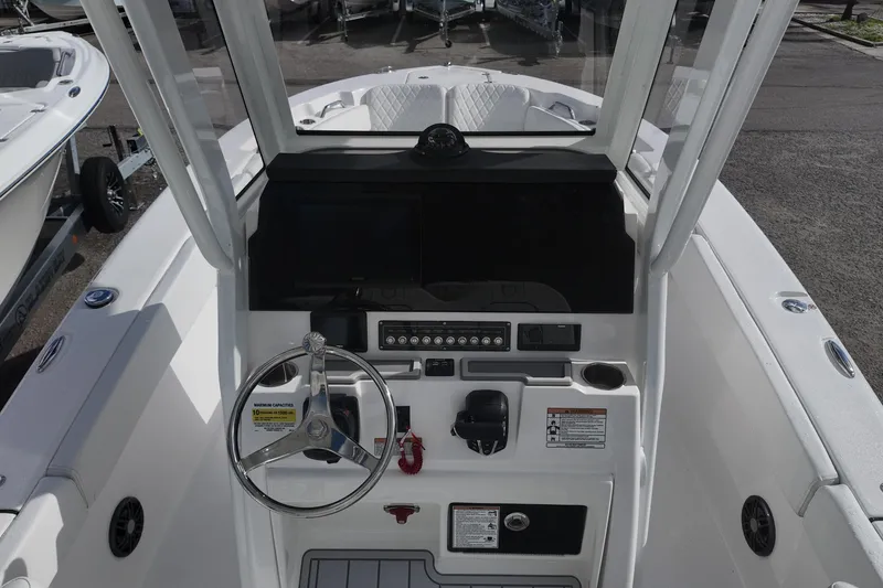 Slide: The Image of 2026 Sea Fox 248 Commander boat dashboard with steering wheel and control panel. - 14