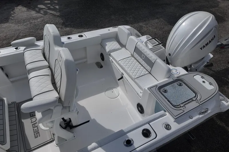 Slide: The Image of 2026 Sea Fox 248 Commander boat interior with Yamaha engine, featuring cushioned seating and storage compartments. - 15