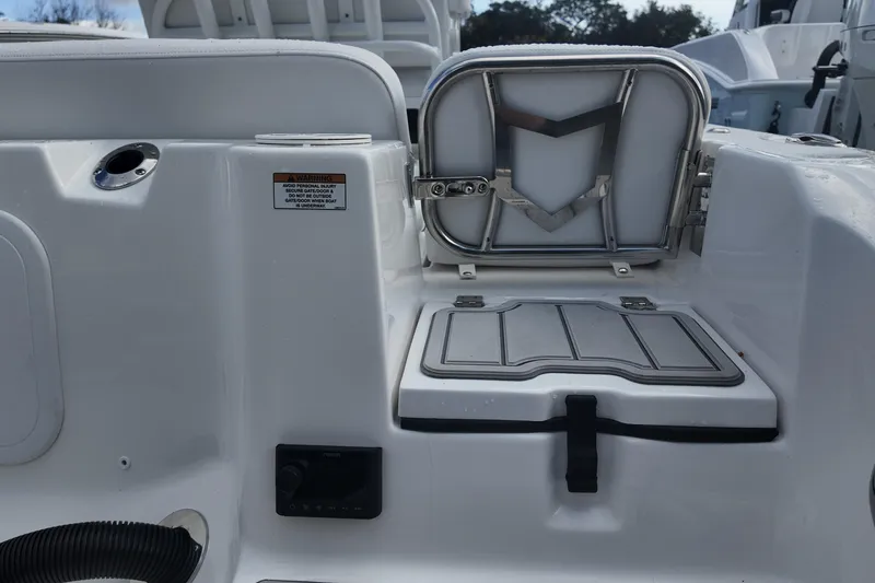 Slide: The Image of 2026 Sea Fox 248 Commander boat interior with storage compartment and warning label. - 18