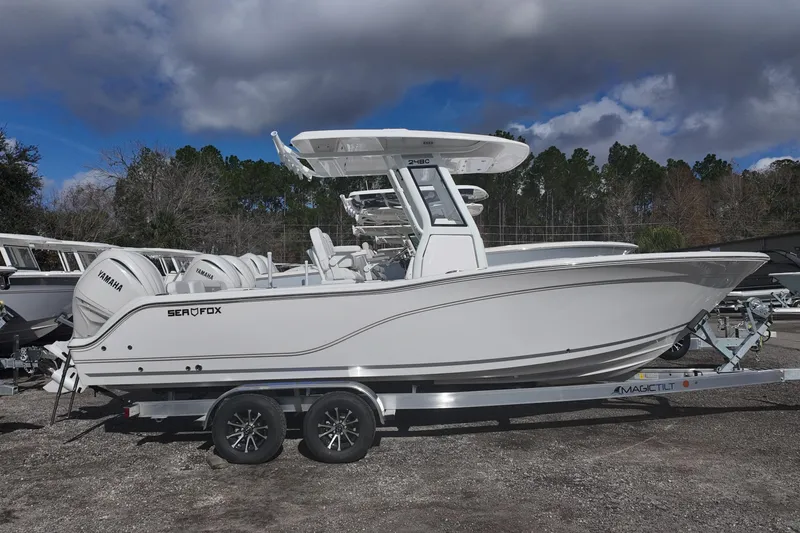 Slide: The Image of 2026 Sea Fox 248 Commander boat on trailer, side view under cloudy sky. - 2