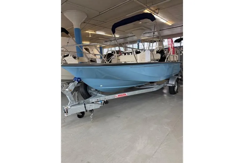 The Image of 2026 Boston Whaler 170 Montauk boat on trailer in showroom. - 0