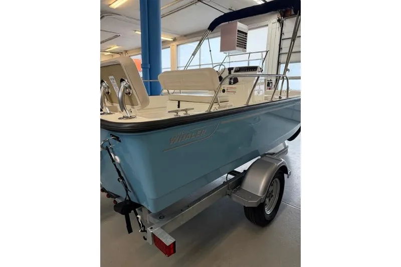 Slide: The Image of 2026 Boston Whaler 170 Montauk boat on trailer in indoor showroom. - 5