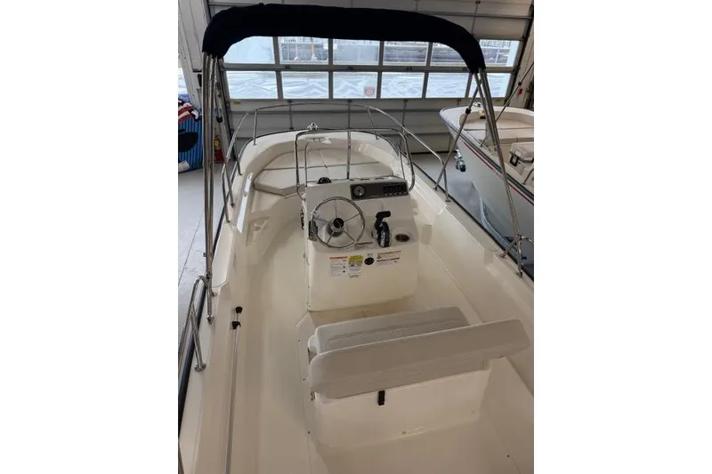 Slide: The Image of 2026 Boston Whaler 170 Montauk boat interior with steering console and seating. - 6