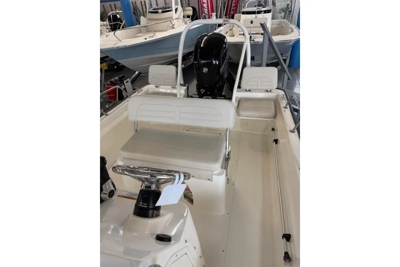 Slide: The Image of 2026 Boston Whaler 170 Montauk boat interior with seating and steering console. - 7