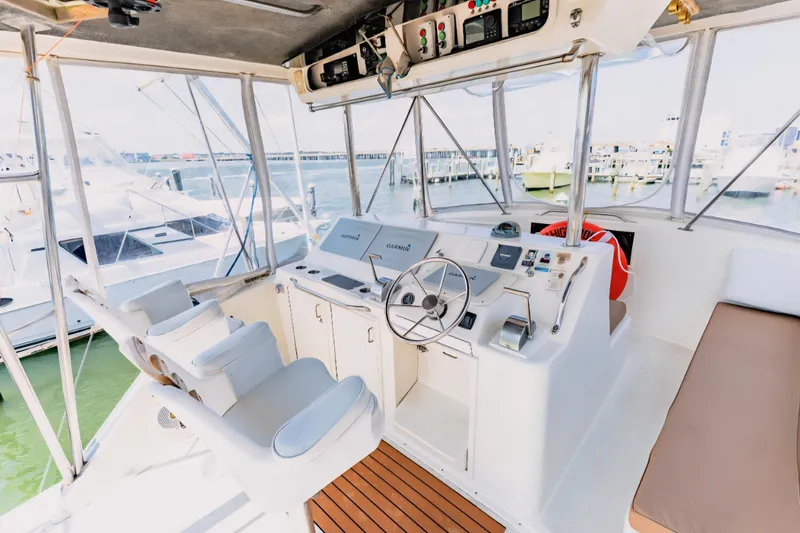 Slide: The Image of Cockpit of 1988 Ocean Yachts 48 Super Sport with helm and seating. - 13