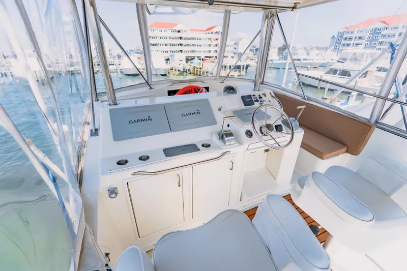 Slide: The Image of 1988 Ocean Yachts 48 Super Sport helm with Garmin navigation, marina view. - 14