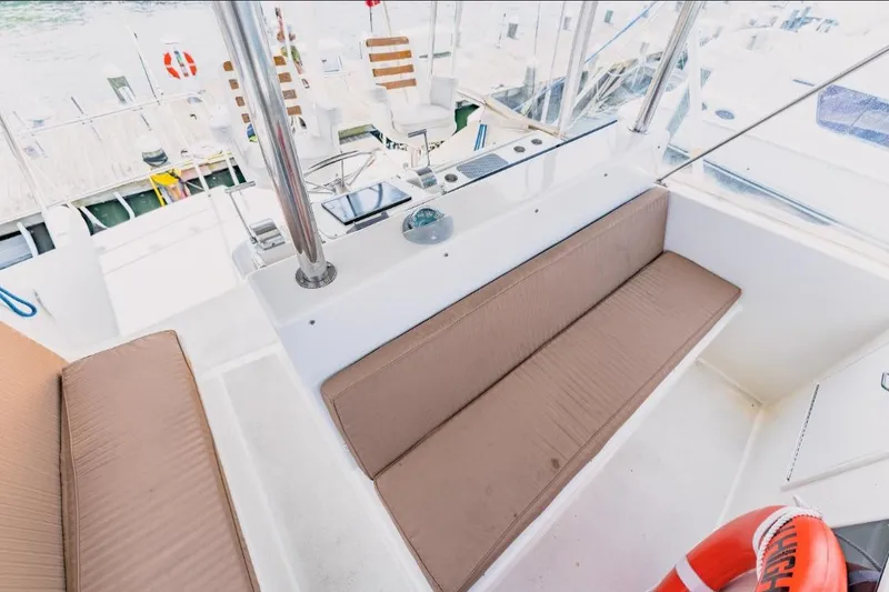 Slide: The Image of 1988 Ocean Yachts 48 Super Sport interior with cushioned seating and nautical decor. - 15