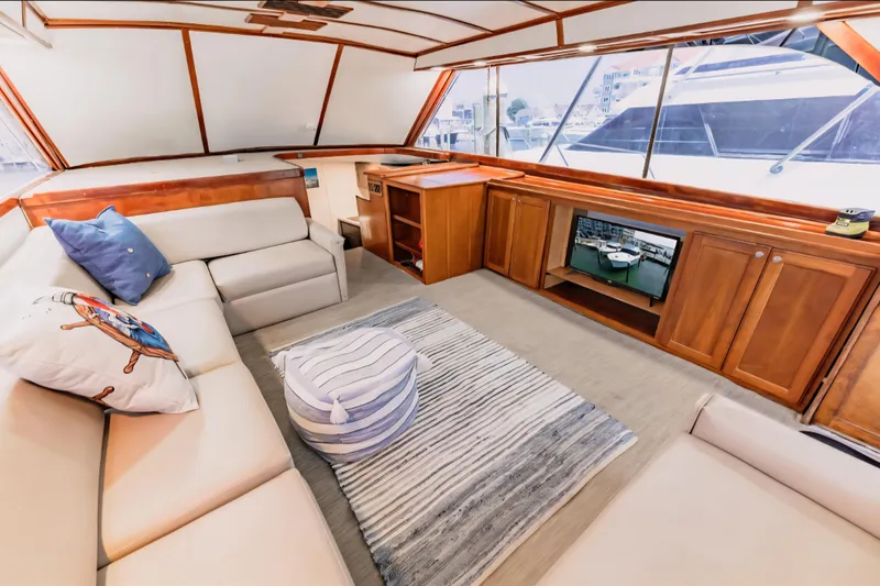 Slide: The Image of Luxurious interior of 1988 Ocean Yachts 48 Super Sport with cozy seating and elegant wood finishes. - 20