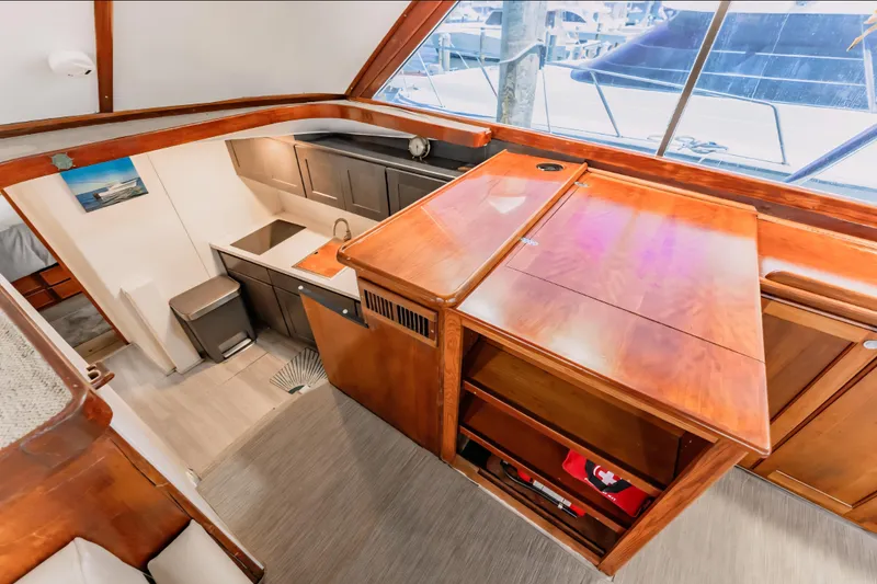 Slide: The Image of 1988 Ocean Yachts 48 Super Sport interior with wooden cabinetry and modern kitchen area. - 22