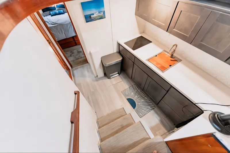 Slide: The Image of 1988 Ocean Yachts 48 Super Sport interior with modern kitchen and cozy bedroom. - 23