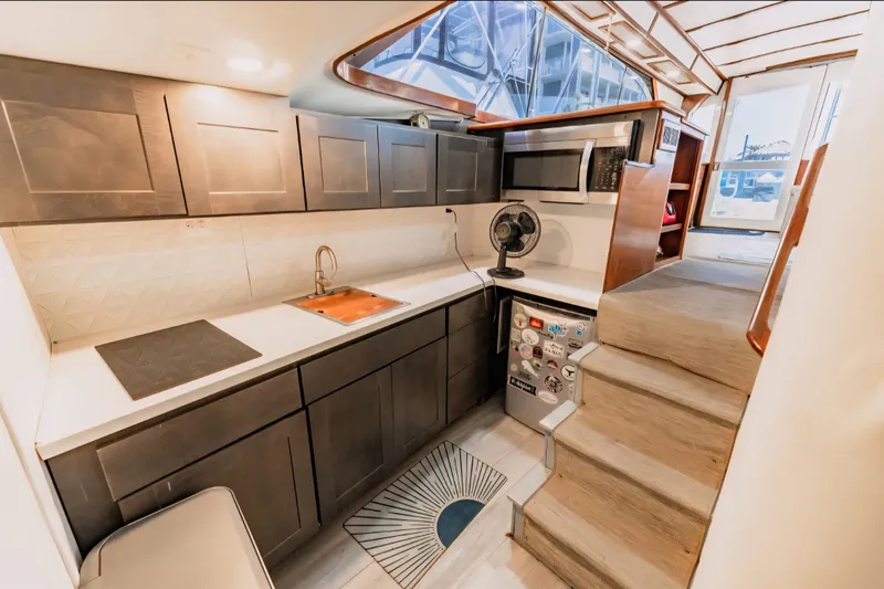 Slide: The Image of Luxurious 1988 Ocean Yachts 48 Super Sport kitchen with modern cabinetry and appliances. - 25