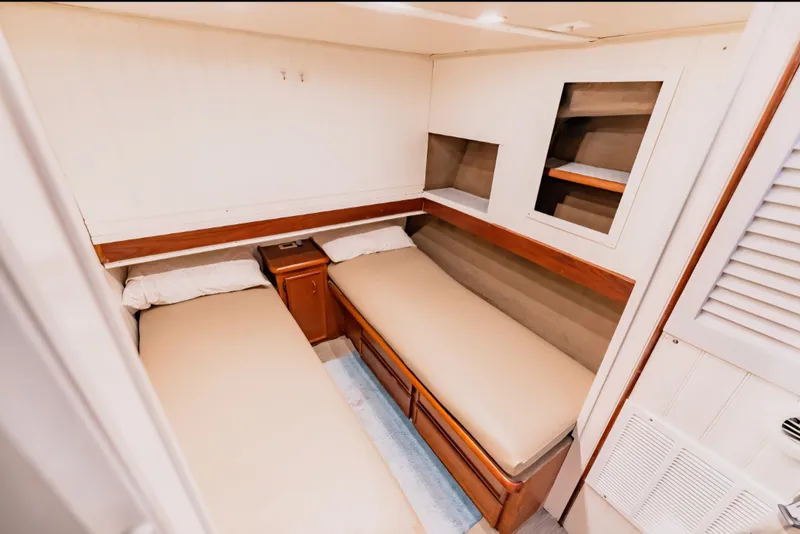 Slide: The Image of 1988 Ocean Yachts 48 Super Sport cabin with twin beds and wooden storage. - 26