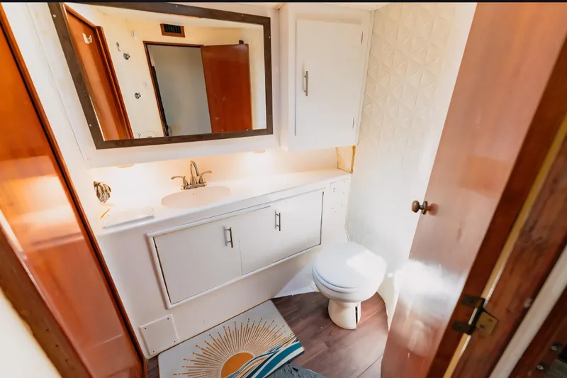 Slide: The Image of Bathroom interior of 1988 Ocean Yachts 48 Super Sport with sink, mirror, and toilet. - 27