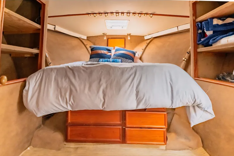 Slide: The Image of Cozy cabin interior of 1988 Ocean Yachts 48 Super Sport with bed and storage. - 28